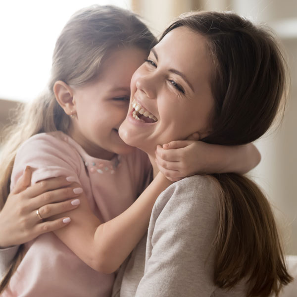 Mother and daughter happily smiling
