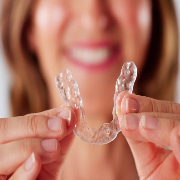 Woman showing clear aligners