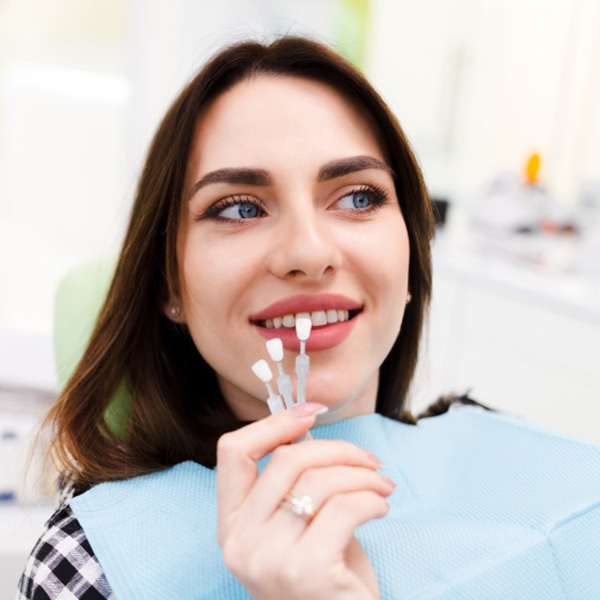 Woman trying on dental veneers at dentist