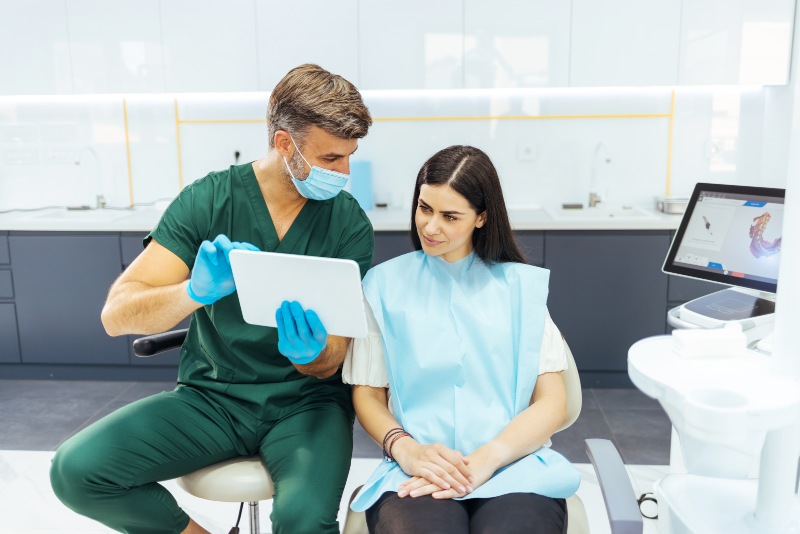 Dentist reviewing dental filling aftercare with patient in Mokena, IL