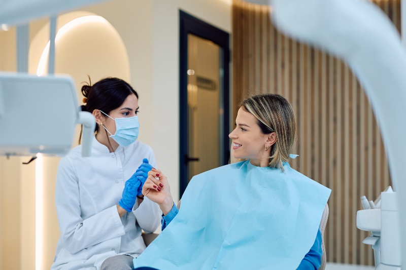Dental consultation explaining tooth bonding treatment options to the patient in Mokena, IL